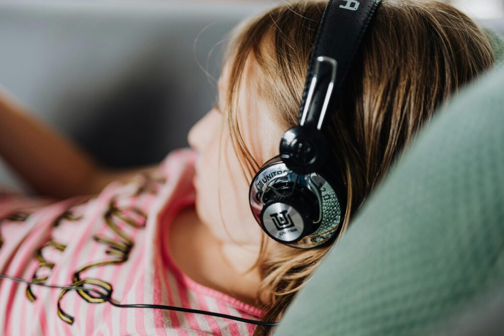 child listening to headphones